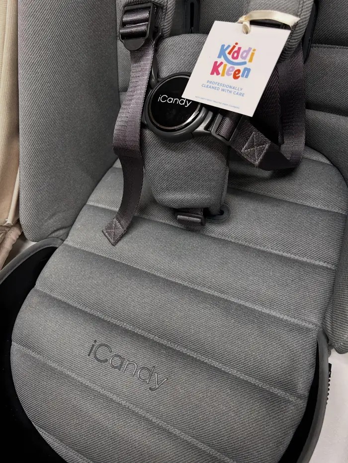 A grey iCandy seat unit after cleaning, with a Kiddi Kleen tag